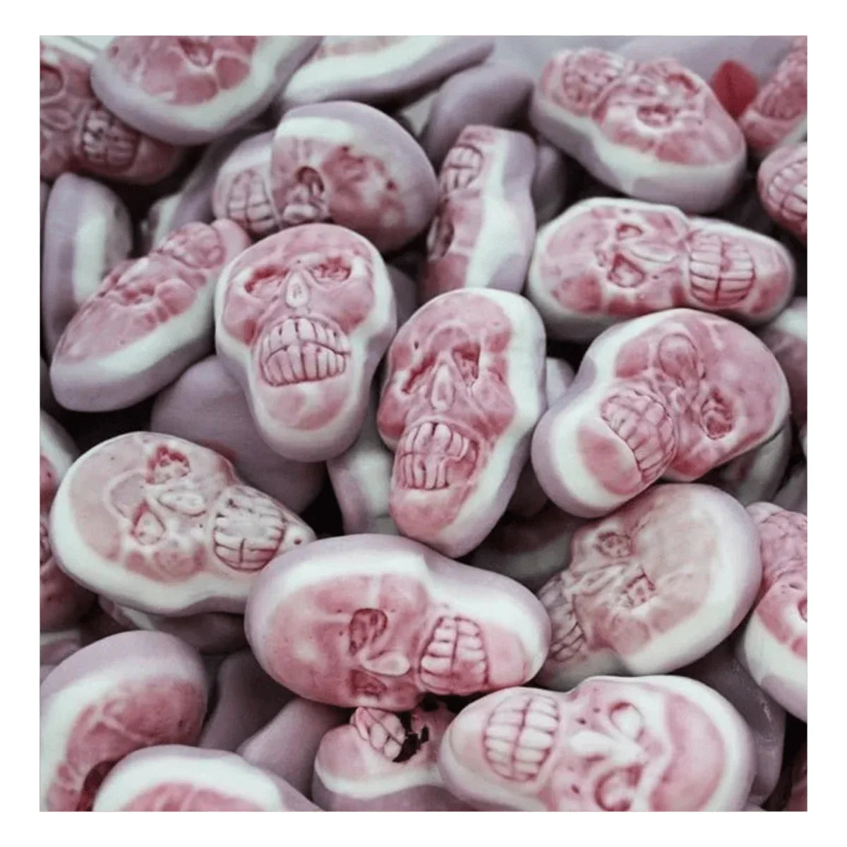 Gummy Galaxy jelly-filled skulls, colorful jelly sweets with skull shape, displayed in a clear container.