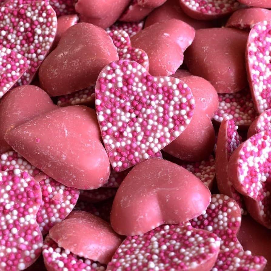 Pink Strawberry Hearts milk chocolate candies from Gummy Galaxy, featuring heart-shaped pink and red chocolates with strawberry flavor.
