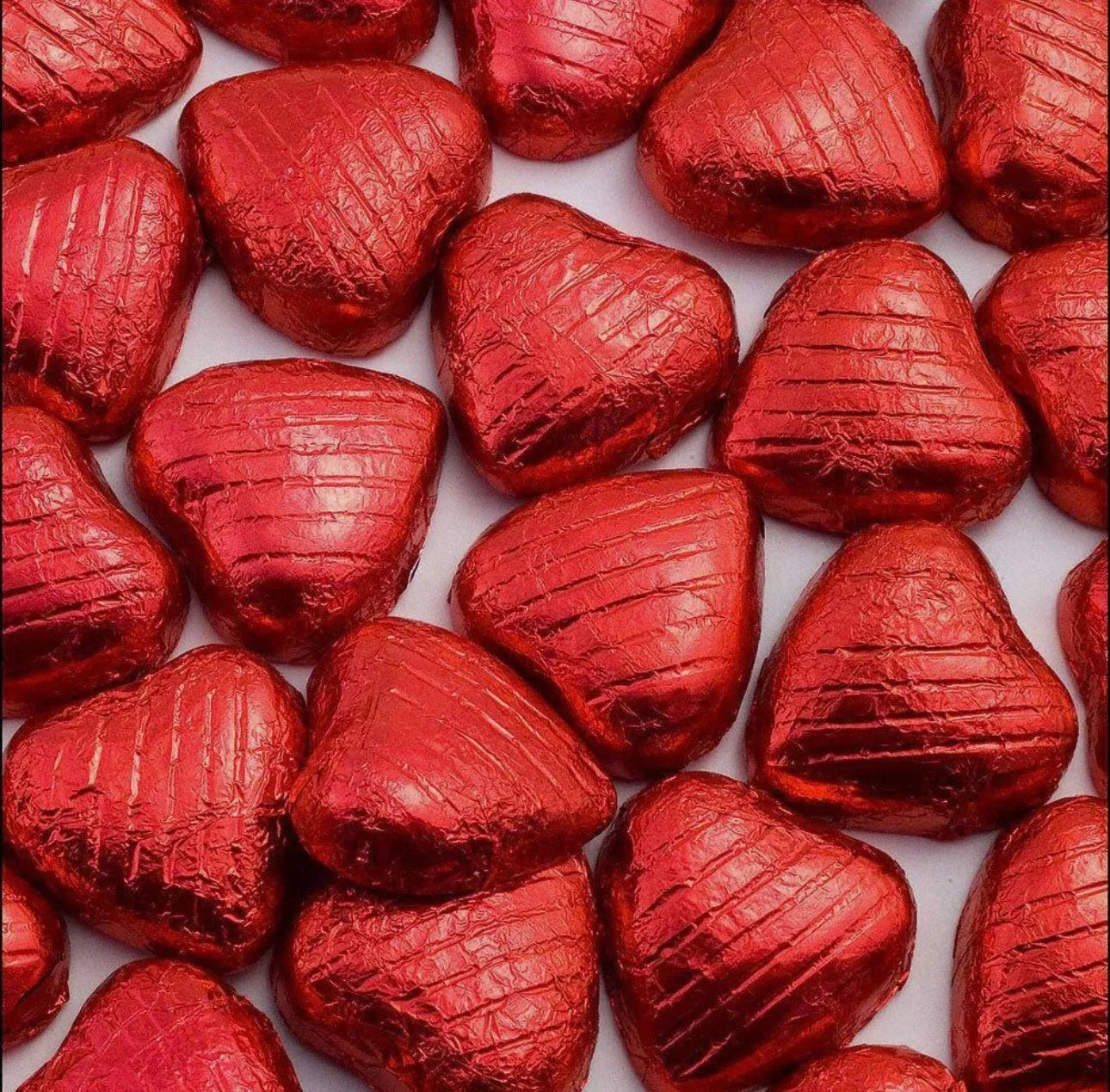Foiled Gummy Galaxy milk chocolate Valentine hearts in a 100-gram packet, featuring shiny foil-wrapped heart-shaped chocolates.